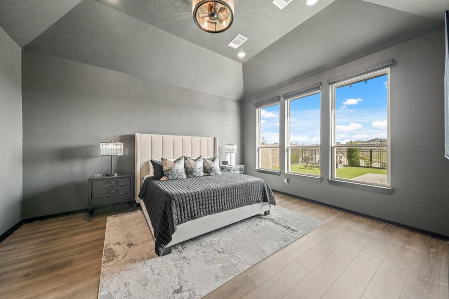 The 17’ x 14’ owner’s suite has AMAZING views of the lake and the backyard with pool and spa, and features a tray ceiling, recessed lights and a ceiling fan with an integrated light.