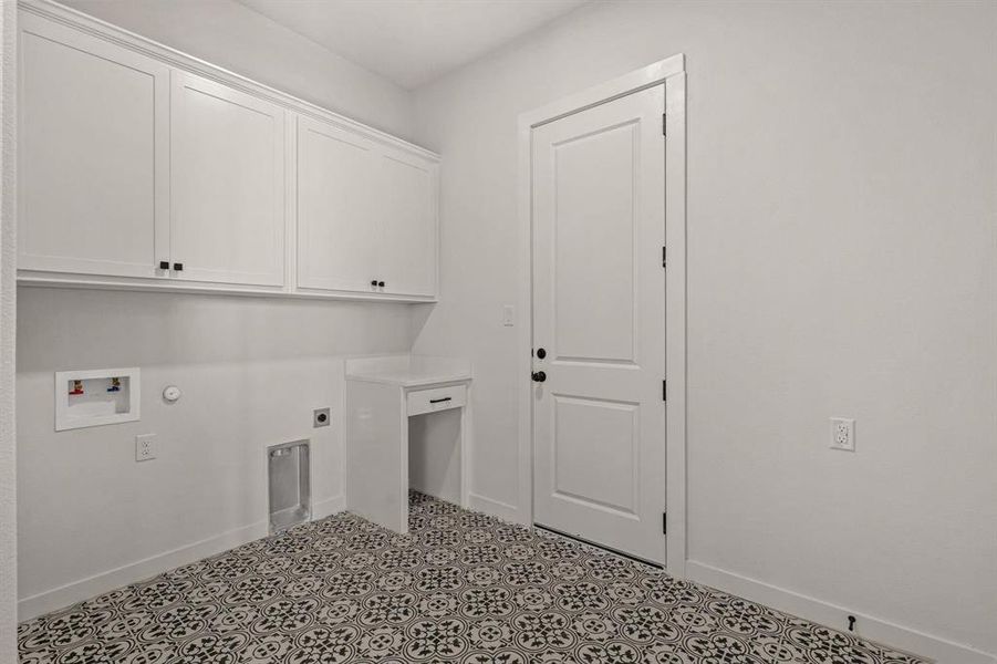 Washroom with cabinet space, electric dryer hookup, washer hookup, and baseboards