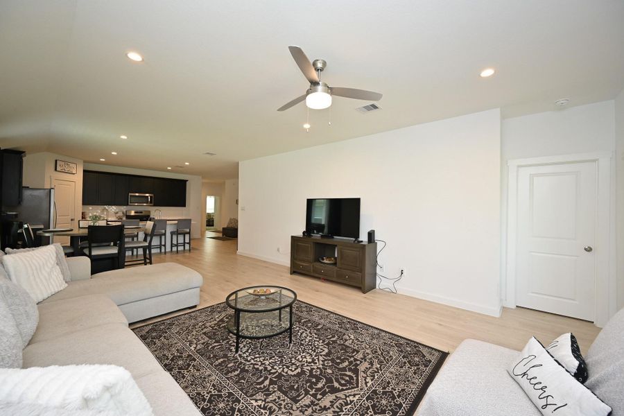 Spacious open-concept living area with a modern kitchen, featuring sleek cabinets and stainless steel appliances. The space is bright and inviting, perfect for entertaining. Spacious open-concept living area with a modern kitchen, featuring sleek cabinets and stainless steel appliances. The space is bright and inviting, perfect for entertaining.