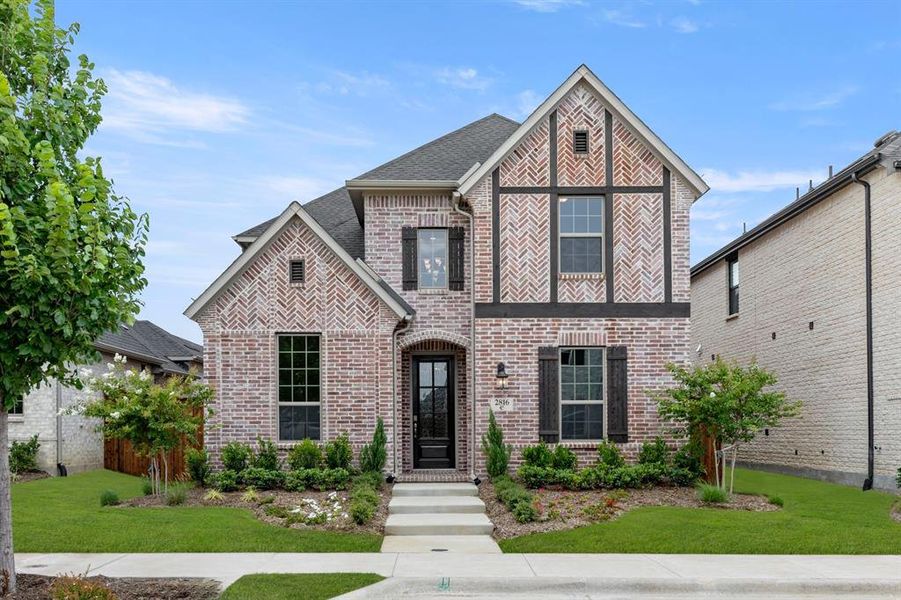 Front exterior of a new home in Cambridge Crossing, Celina, TX, highlighting curb appeal (Image 17).