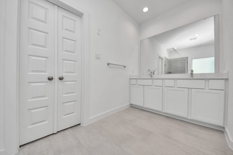 Elevate your daily routine at the elegant vanity, now equipped with double sinks, light countertops, modern hardware, and beautiful recessed lights. Sample photo of completed home with similar floor plan. Actual colors and selections may vary. Elevate your daily routine at the elegant vanity, now equipped with double sinks, light countertops, modern hardware, and beautiful recessed lights. Sample photo of completed home with similar floor plan. Actual colors and selections may vary.