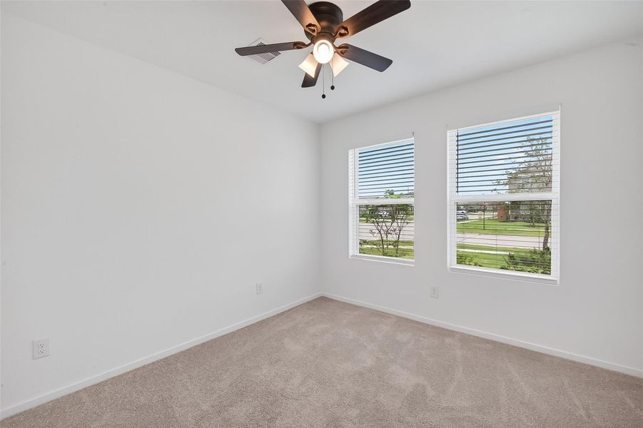 One of the secondary bedrooms located at the front of the house.