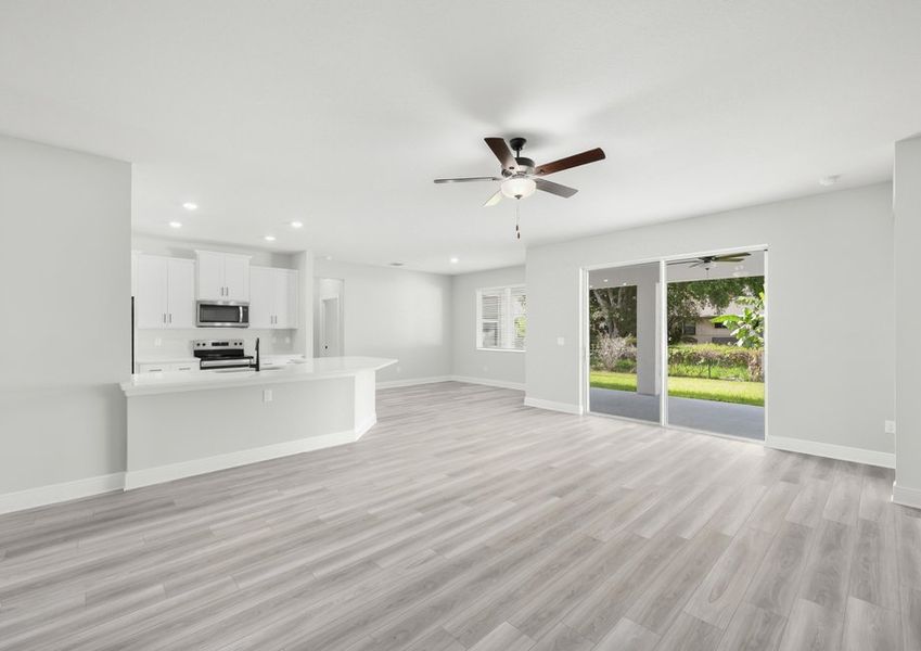The living room is the hub of the home connecting the back patio with the kitchen and dinning room