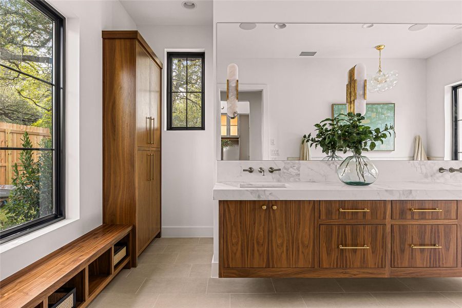 Luxurious bath features an elegant freestanding tub and dual vanity.