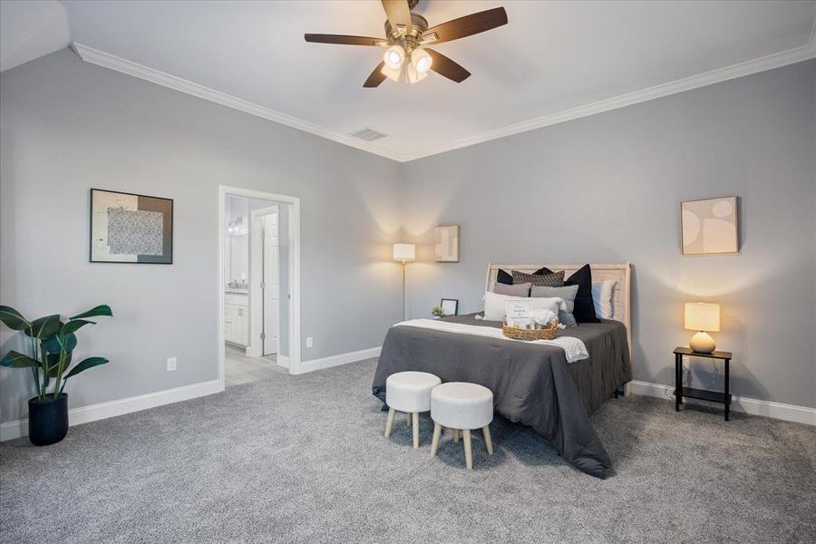 Primary bedroom with crown molding, ensuite bath, and ceiling fan