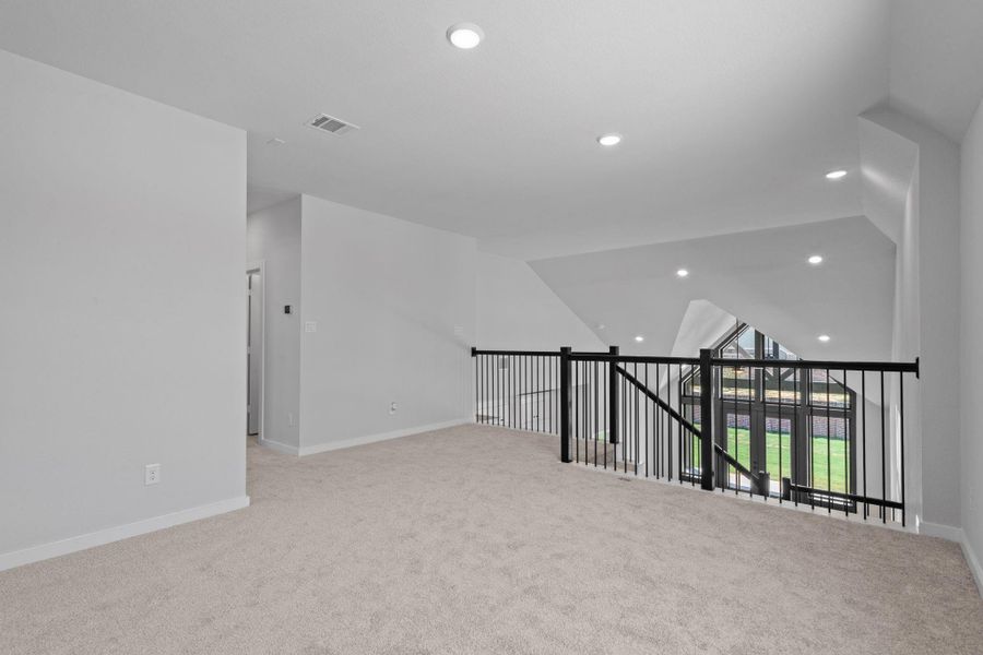 The game room overlooks the huge family room below. The game room overlooks the huge family room below.