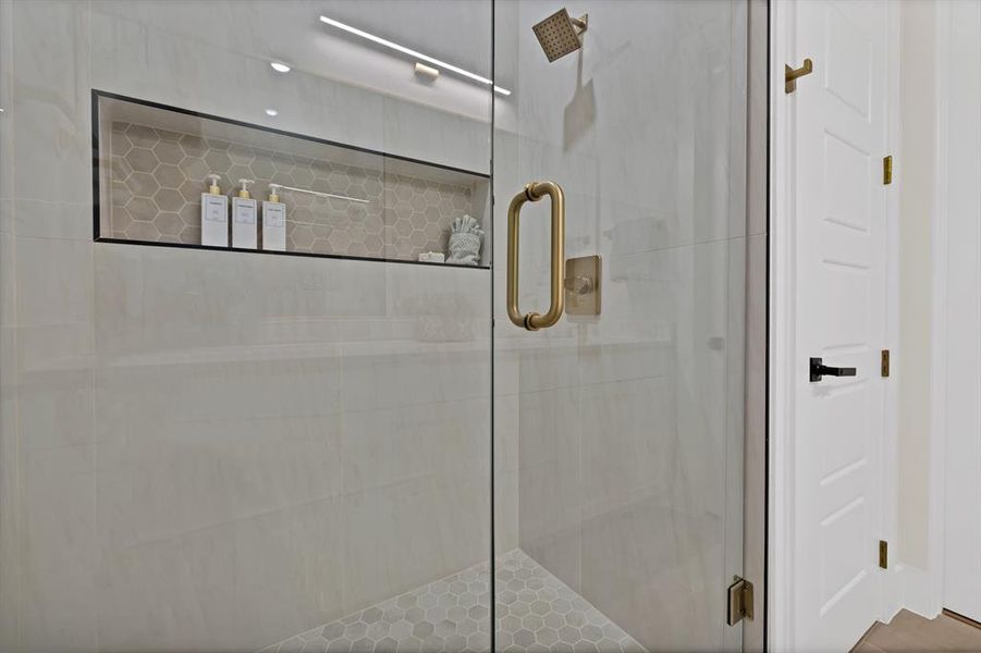 Full bath featuring a shower stall Full bath featuring a shower stall