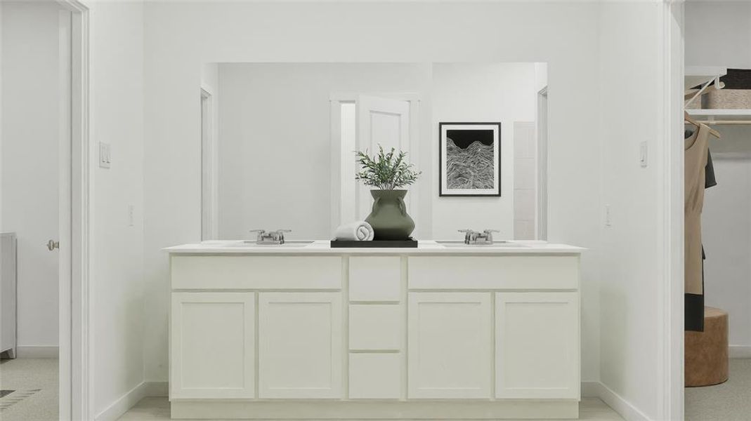 Bathroom featuring double vanity and a spacious closet