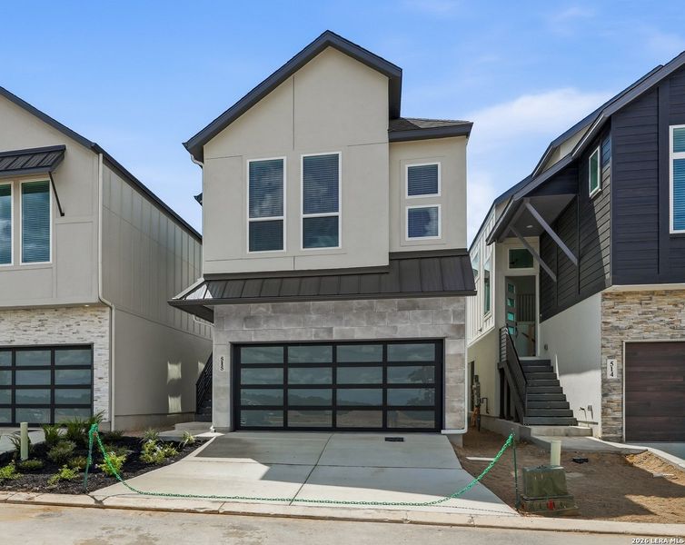 Front exterior of a new home in Centero at Stone Oak, San Antonio, TX, highlighting curb appeal (Image 2).