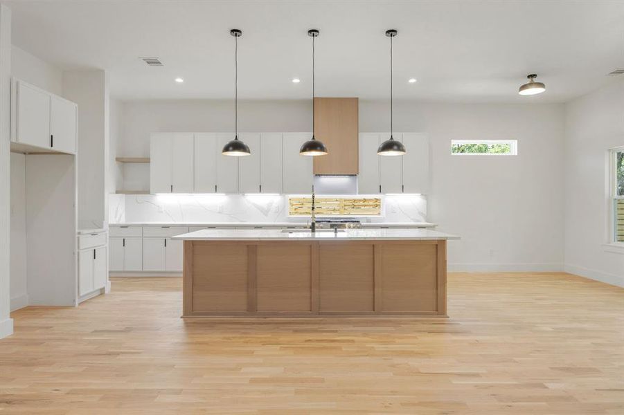 The expansive chef's kitchen serves as the heart of the home, featuring a large center island and an open-concept design that seamlessly connects to the spacious living and dining areas. This inviting layout is ideal for everyday living, effortless entertaining, and creating lasting memories with family and friends. The expansive chef's kitchen serves as the heart of the home, featuring a large center island and an open-concept design that seamlessly connects to the spacious living and dining areas. This inviting layout is ideal for everyday living, effortless entertaining, and creating lasting memories with family and friends.