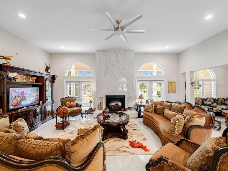 Fire place with porcelain slab to ceiling and French doors to lanai