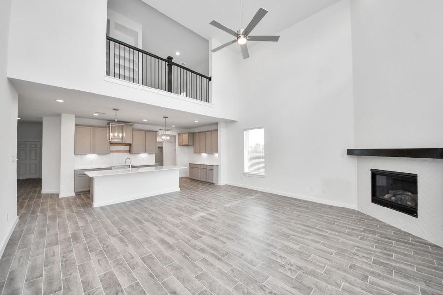 Family room flooded with natural light through the expansive windows. The premium tile flooring adds a touch of luxury to the space, creating the perfect setting for relaxing moments and cherished gatherings with loved ones Family room flooded with natural light through the expansive windows. The premium tile flooring adds a touch of luxury to the space, creating the perfect setting for relaxing moments and cherished gatherings with loved ones