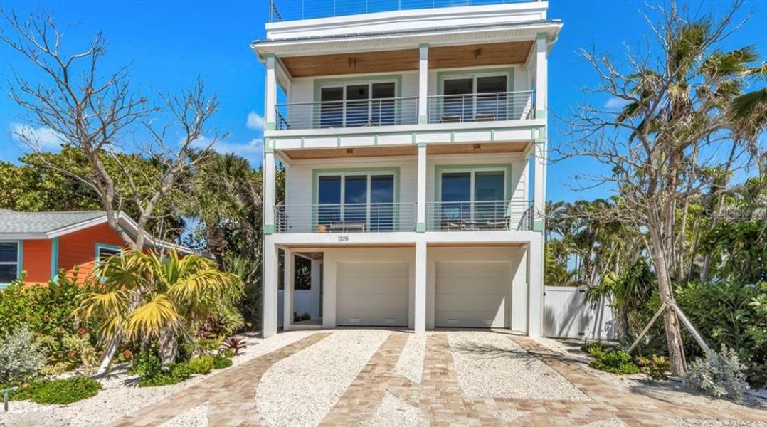 Front exterior of a new home in , Bradenton Beach, FL, highlighting curb appeal (Image 1). Front exterior of a new home in , Bradenton Beach, FL, highlighting curb appeal (Image 1).