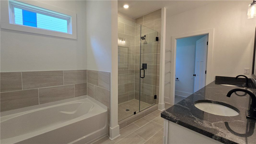 Luxurious bathroom offering a spacious shower, a c