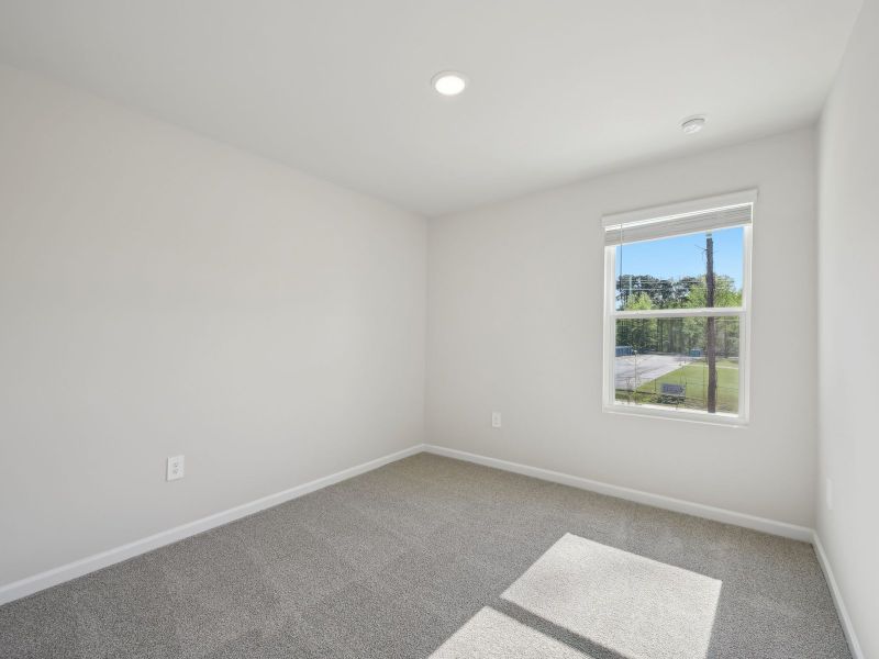 Two secondary bedrooms are ideally situated away from the primary suite.