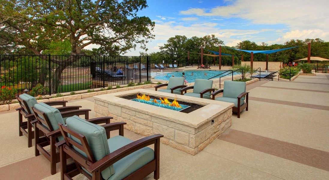 An inviting community space with a fire pit, comfortable seating, and an adjacent swimming pool.