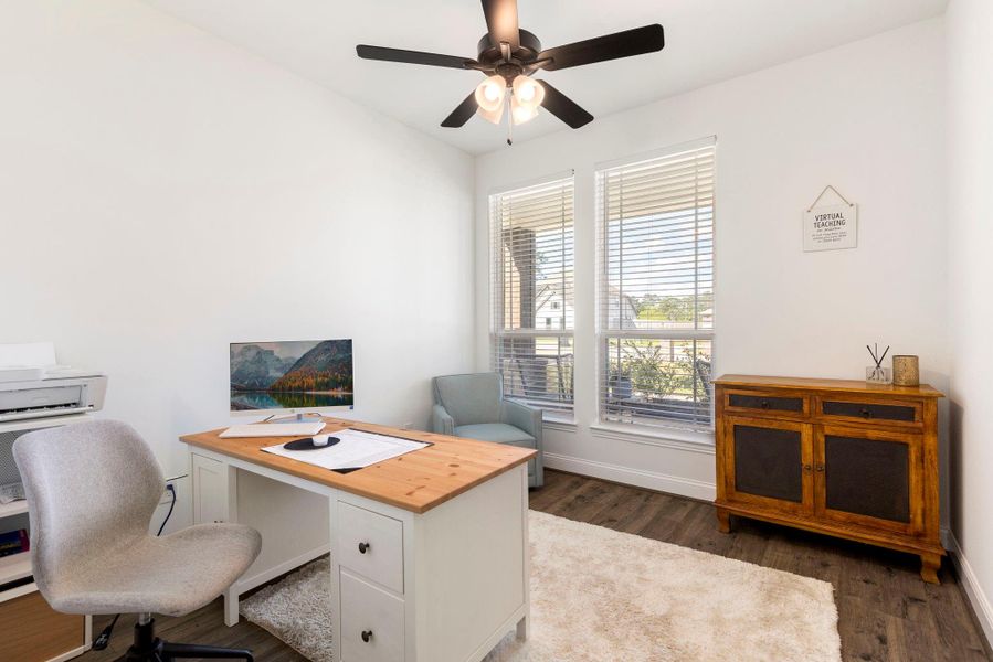 Bright home office with large windows, is perfect for productivity in a serene setting.