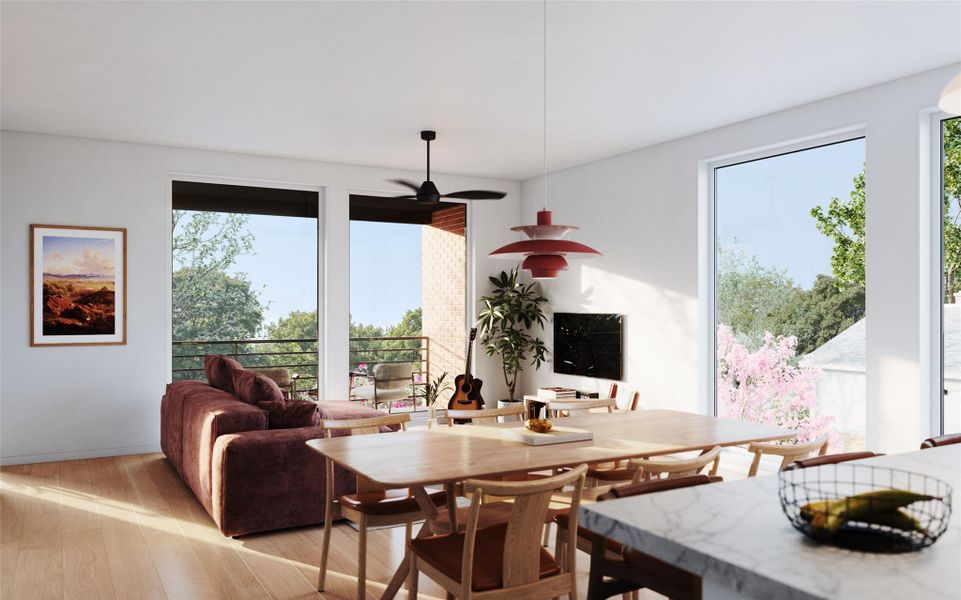 Living area featuring luxury wood flooring, floor to ceiling windows, and a covered balcony