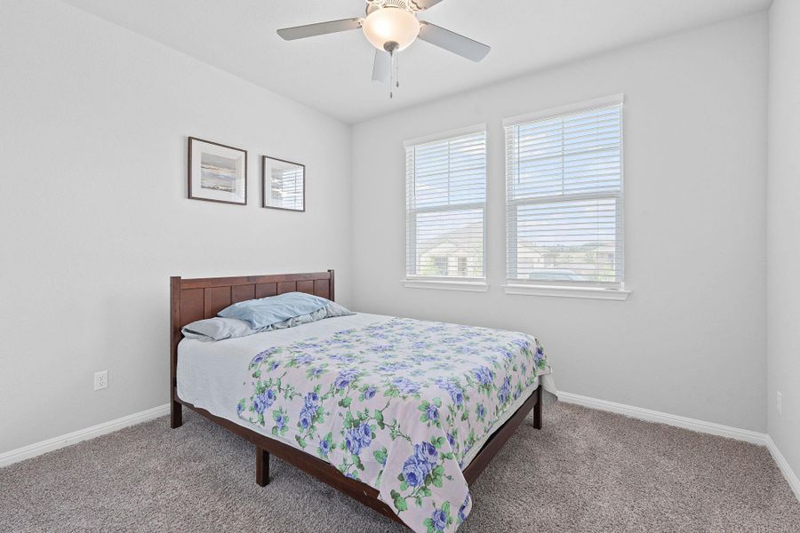 Bedroom with baseboards and carpet flooring Bedroom with baseboards and carpet flooring