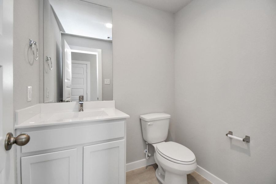 This half bathroom features a stylish pedestal sink, modern hardware, and bright recessed lighting, creating a sleek and inviting space. Sample photo of completed home with similar floor plan. Actual colors and selections may vary. This half bathroom features a stylish pedestal sink, modern hardware, and bright recessed lighting, creating a sleek and inviting space. Sample photo of completed home with similar floor plan. Actual colors and selections may vary.