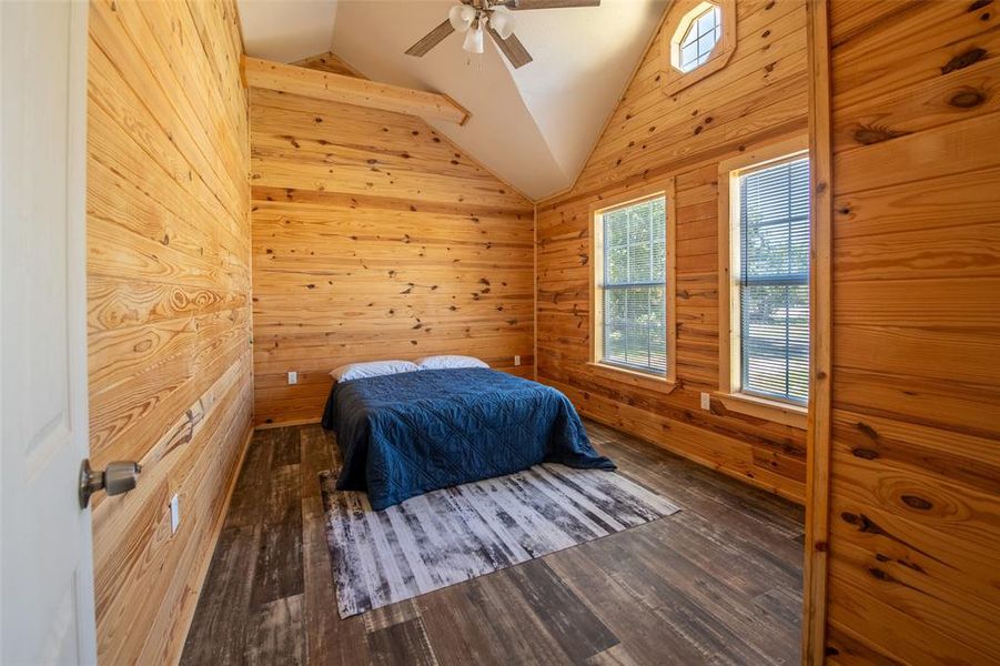 Room featuring wood-plank walls and wood-finish flooring