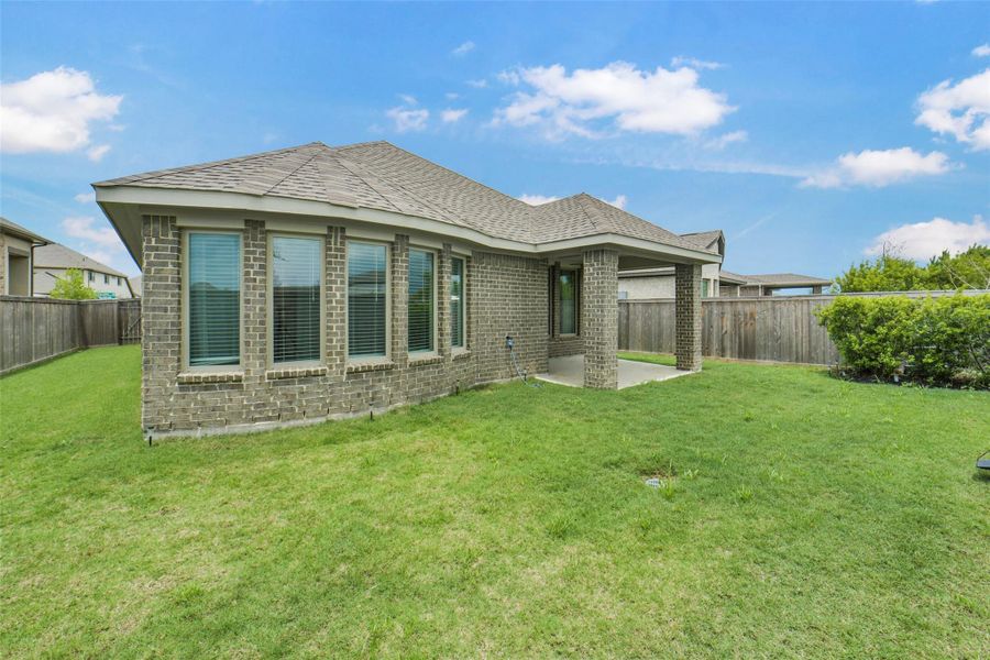 Exterior details and patio area of a home in Bridgeland, Cypress (Image 24).