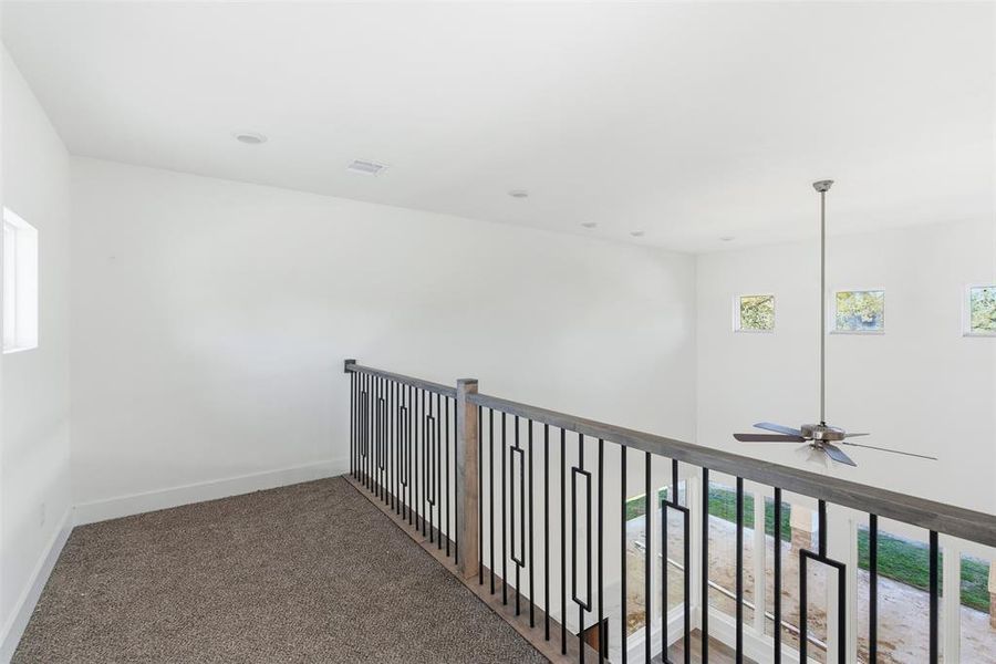 Hallway featuring healthy amount of natural light and carpet floors Hallway featuring healthy amount of natural light and carpet floors