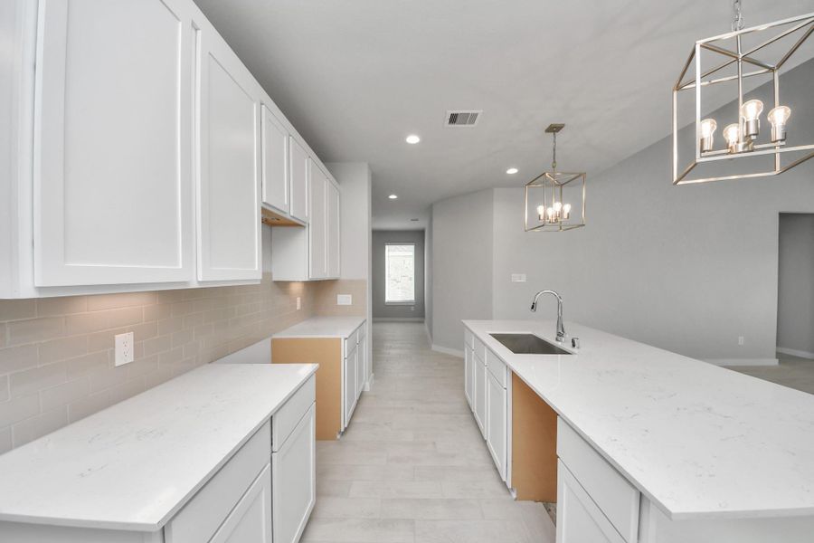 The extended counter area adds both practicality and style, making meal preparation a breeze. Every detail is thoughtfully designed to enhance the kitchen's functionality and aesthetic appeal. Sample photo of completed home with similar floor plan. Actual colors and selections may vary. The extended counter area adds both practicality and style, making meal preparation a breeze. Every detail is thoughtfully designed to enhance the kitchen's functionality and aesthetic appeal. Sample photo of completed home with similar floor plan. Actual colors and selections may vary.