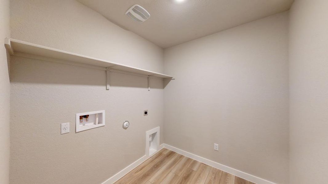 Laundry room featuring hookup for a gas dryer, washer hookup, electric dryer hookup, and light wood-style floors