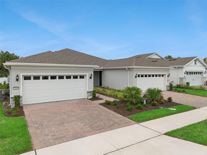 Front exterior of a new home in Del Webb Oasis, Winter Garden, FL, highlighting curb appeal (Image 21).