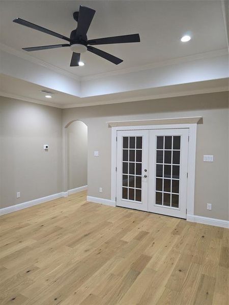 Unfurnished room with crown molding, light hardwood / wood-style floors, and ceiling fan