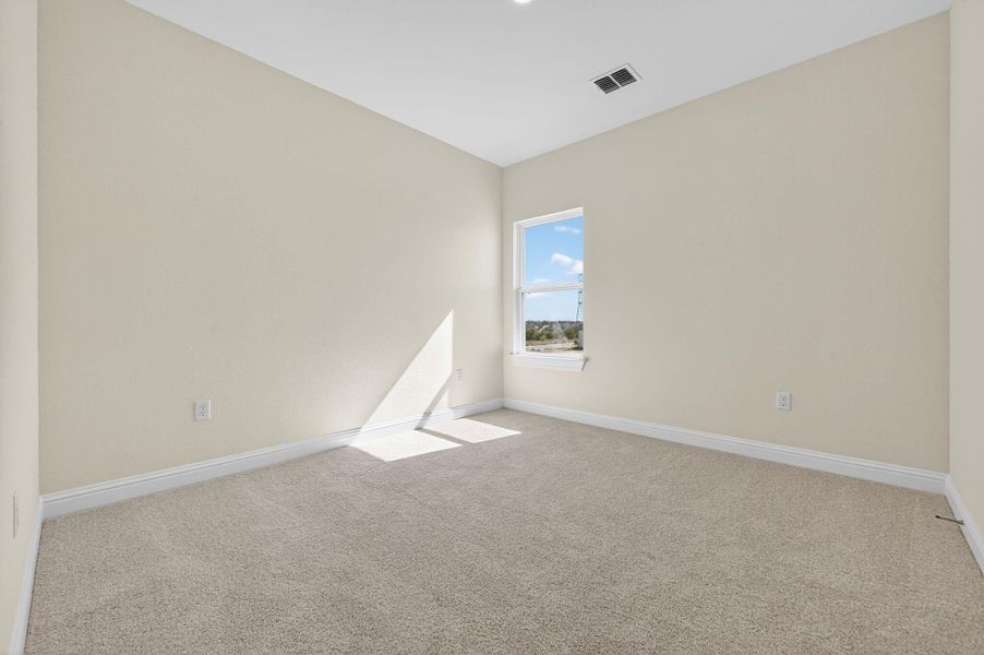 Unfurnished room with carpet flooring and lofted ceiling