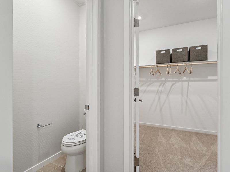 A bathroom with a shower unit and toilet.