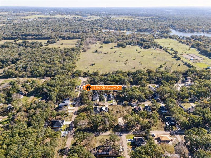 Birds eye view of property with a water view