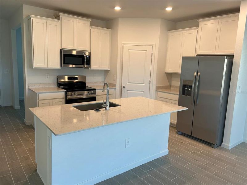 Kitchen with SS appliances and quartz countertops