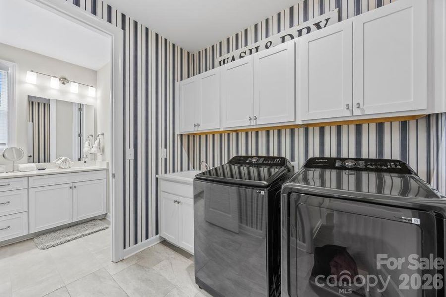 Designer wall coverings in laundry room (accesible from primary BR and hallway)