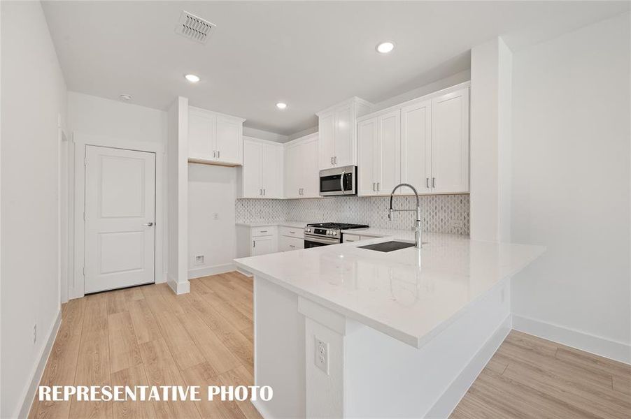 The kitchen of your dreams features fantastic storage, plenty of prep space and a breakfast bar that can do double duty as a homework station or place to grab a quick bite.  REPRESENTATIVE PHOTO