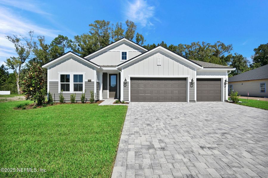 Front exterior of a new home in McGirt's Creek, Yulee, FL, highlighting curb appeal (Image 1).