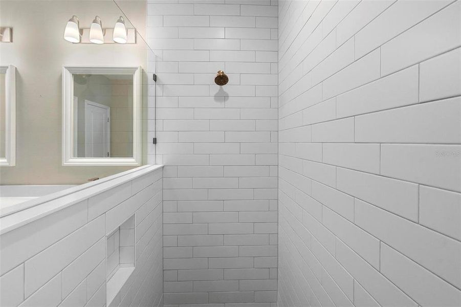 Upgraded floor-to-ceiling subway tile elevate this bath suite, making it Truly unique and rich in thoughtful details.