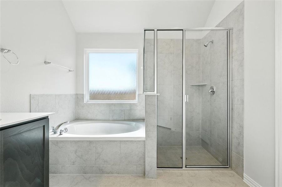 Full bath with vanity, a stall shower, and a bath