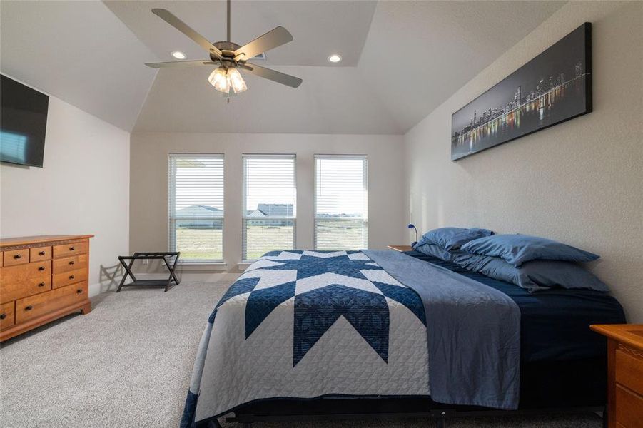 Bedroom featuring recessed lighting, ceiling fan, carpet flooring, and vaulted ceiling