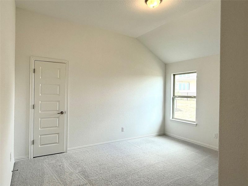 Spare room with carpet and lofted ceiling Spare room with carpet and lofted ceiling