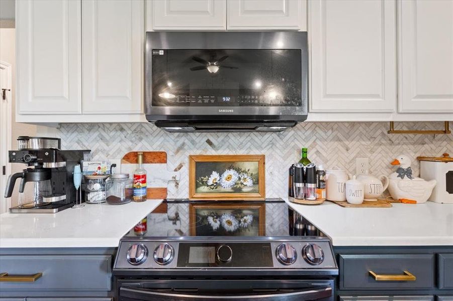 Kitchen with stainless steel range with electric cooktop, white cabinetry, and backsplash