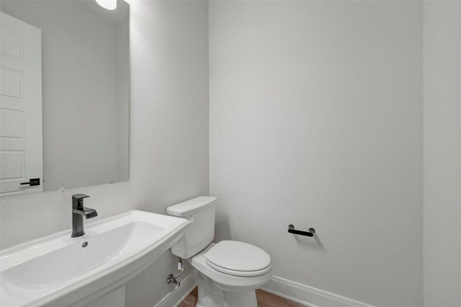 Half bathroom with a sink and toilet