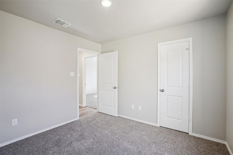 Unfurnished bedroom featuring carpet floors and baseboards