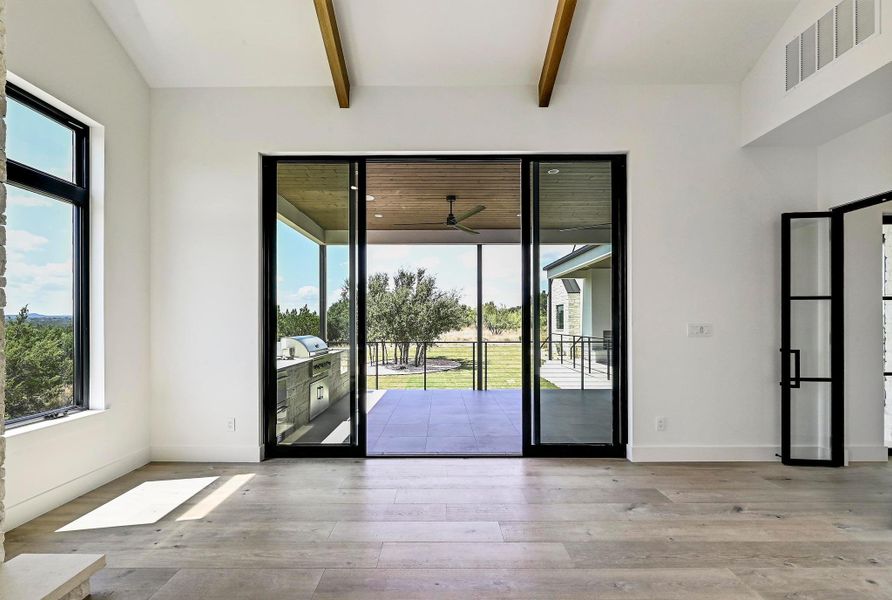 View in den looking out to patio and outdoor kitchen. View in den looking out to patio and outdoor kitchen.