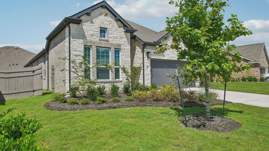 Front exterior of a new home in Artavia, Conroe, TX, highlighting curb appeal (Image 24).