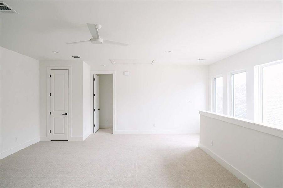 Spare room with light carpet and ceiling fan