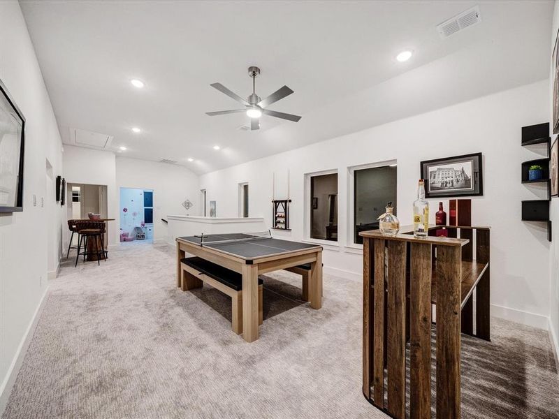 Rec room with light carpet, lofted ceiling, a ceiling fan, and recessed lighting Rec room with light carpet, lofted ceiling, a ceiling fan, and recessed lighting