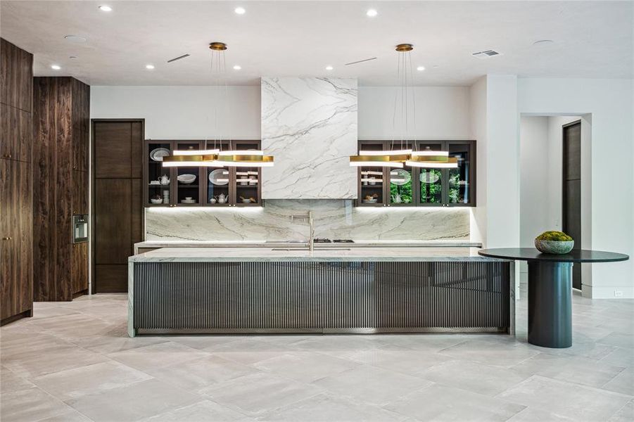 This chef's kitchen is a culinary paradise where elegance meets functionality, with a kitchen adorned by White Pearl Francini Quartzite countertops on the island and leathered natural stone on the breakfast table, illuminated by Modern Forms Linear Pendants in Aged Brass. The space is as practical as it is luxurious, featuring a Rohl under-mount double bowl sink, complemented by Waterstone pull-out spray and pot filler faucets in Satin Nickel, offering both style and convenience for gourmet endeavors.